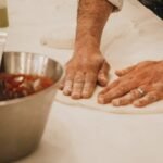 a man showing Italian Pizza cooking tips