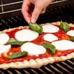 A man Grilling the Perfect Pizza
